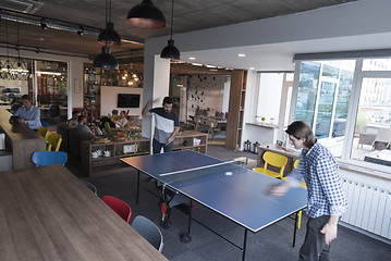 Image showing playing ping pong tennis at creative office space