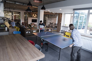 Image showing playing ping pong tennis at creative office space