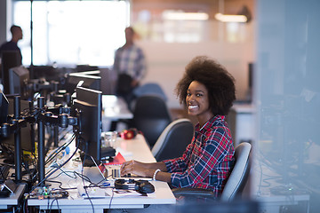 Image showing young black woman at her workplace in modern office