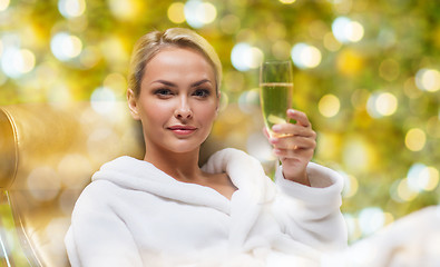 Image showing beautiful young woman drinking champagne at spa