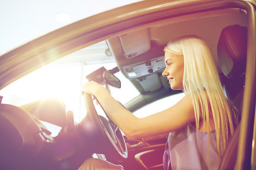 Image showing happy woman inside car in auto show or salon