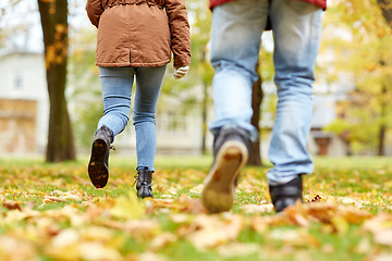 Image showing young couple running in autumn park