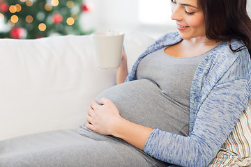 Image showing close up of pregnant woman drinking tea at home