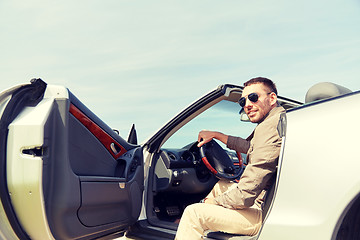 Image showing happy man opening door of cabriolet car outdoors