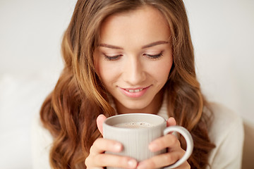 Image showing close up of happy woman with coffee cup at home