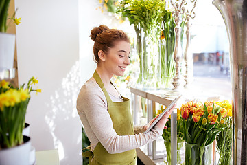 Image showing woman with tablet pc computer at flower shop