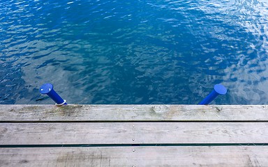 Image showing Wooden wharf and blue water