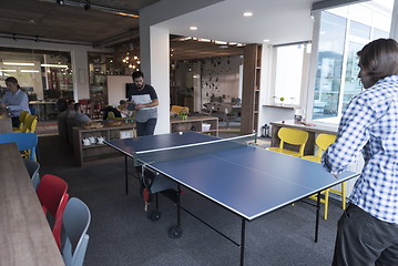 Image showing playing ping pong tennis at creative office space