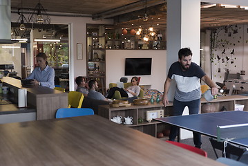 Image showing playing ping pong tennis at creative office space