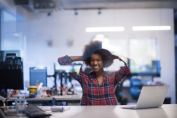 Image showing young black woman at her workplace in modern office  African-Ame