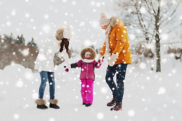 Image showing happy family in winter clothes walking outdoors