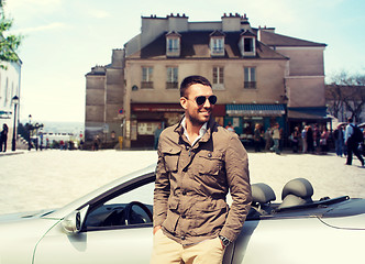 Image showing happy man driving cabriolet car over city