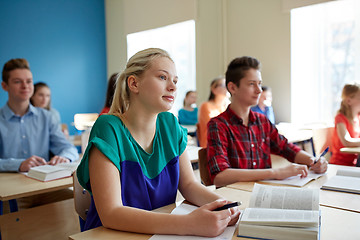 Image showing group of students with books at school lesson