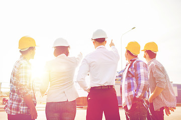 Image showing group of builders and architects at building site