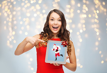 Image showing woman s with santa claus on tablet pc screen