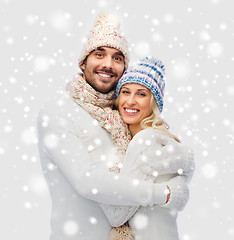 Image showing smiling couple in winter clothes hugging