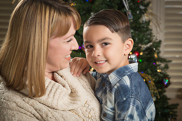 Image showing Mother and Mixed Race Son Hug Near Christmas Tree