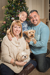 Image showing Young Mixed Race Family In Front of Christmas Tree