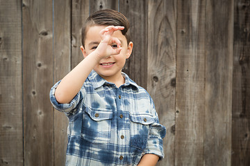 Image showing Young Mixed Race Boy Making Hand Gestures