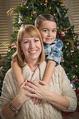 Image showing Mother and Mixed Race Son Hug Near Christmas Tree