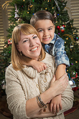 Image showing Mother and Mixed Race Son Hug Near Christmas Tree