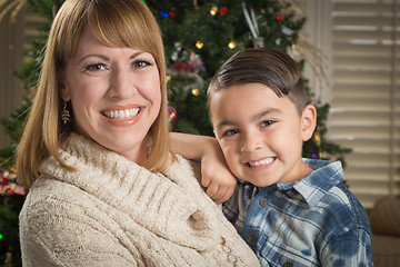 Image showing Mother and Mixed Race Son Hug Near Christmas Tree