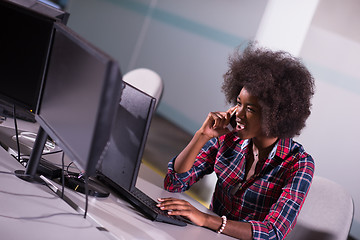 Image showing young black woman at her workplace in modern office
