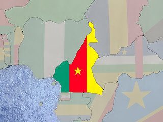Image showing Camerowith flag on with flag on globe