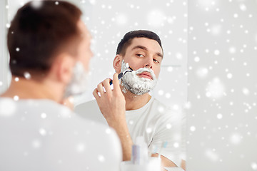 Image showing man shaving beard with razor blade at bathroom