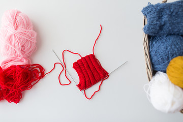 Image showing hand-knitted item with knitting needles