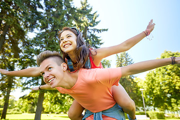 Image showing happy teenage couple having fun at summer park