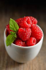 Image showing ripe and fresh raspberry in white cup 
