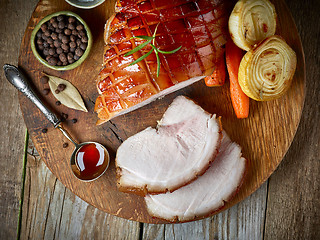 Image showing roasted pork on wooden cutting board