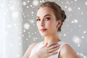 Image showing beautiful woman in white with diamond jewelry