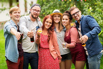 Image showing happy friends with drinks at summer garden party