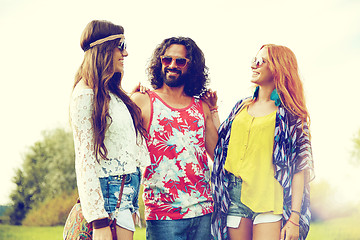 Image showing smiling young hippie friends talking outdoors