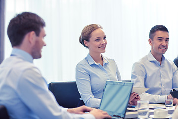 Image showing smiling business people with tablet pc in office