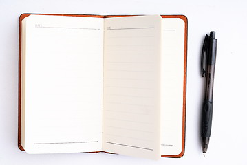 Image showing notepad with pen isolated