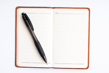 Image showing notepad with pen isolated