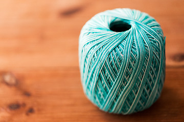 Image showing ball of turquoise cotton yarn on wood