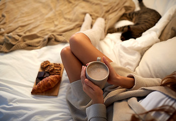 Image showing close up of woman with cocoa cup in bed