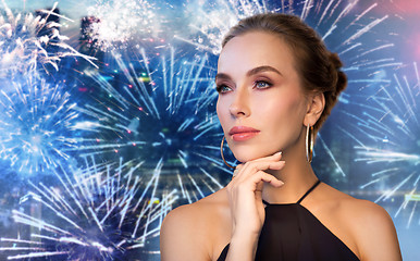 Image showing beautiful woman in black wearing diamond jewelry