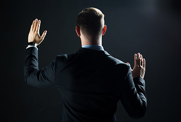 Image showing businessman touching virtual screen