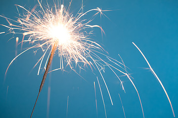 Image showing Christmas sparkler on blue background