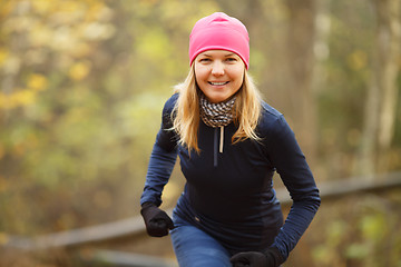 Image showing Beautiful sportswoman running in park