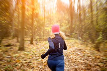 Image showing Girl in pink hat jogging