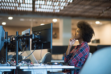 Image showing young black woman at her workplace in modern office