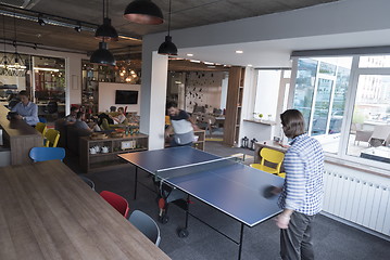 Image showing playing ping pong tennis at creative office space