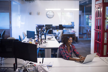 Image showing young black woman at her workplace in modern office  African-Ame