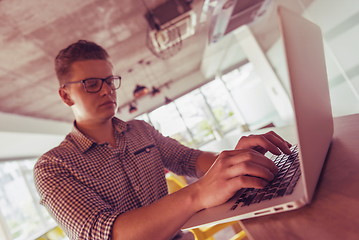 Image showing young  man working on laptop